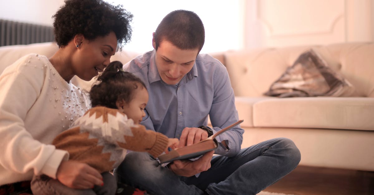 UK visit visa for an infant - how to apply if parents already hold a UK visa? - Photo of Family Sitting on Floor While Reading Book