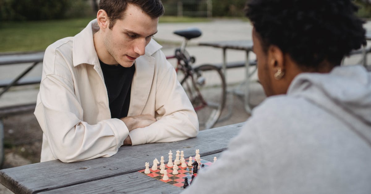 UK visit visa refused due to suspected funds parking. Best strategy to re-apply? - Concentrated young guy in casual clothes thinking while playing chess game with anonymous African American male friend in park