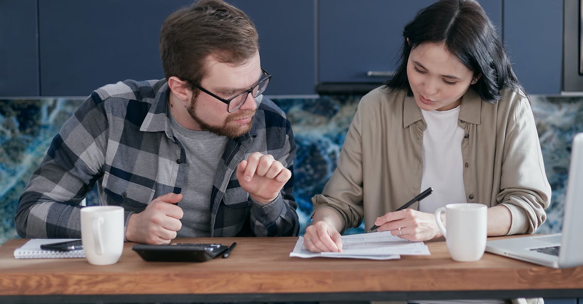 UK visit visa: What documents prove genuine relationship with the visitor? - A Couple Having Conversation while Looking at the Documents UK visit visa: What documents prove genuine relationship with the visitor? - A Couple Having Conversation while Looking at the Documents