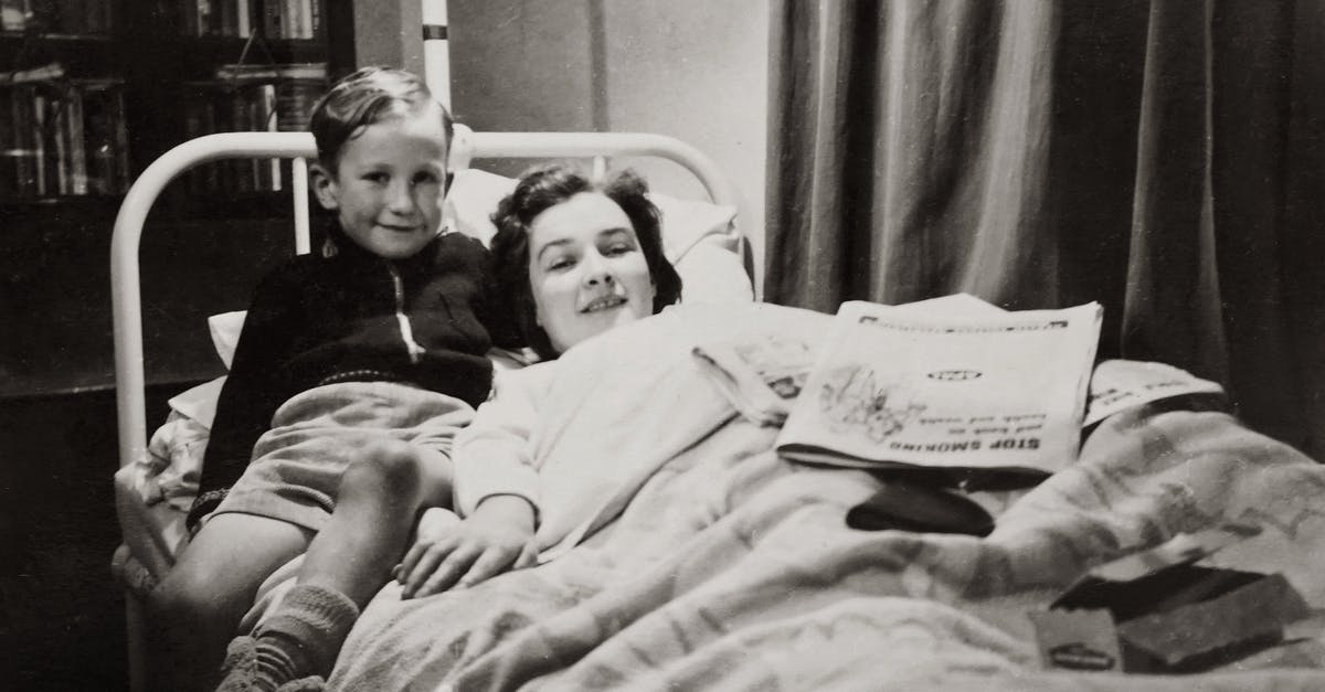 UK visiting visa for a 3 year old child - Grayscale Photo of A Boy Sitting Beside His Mother Lying On A Hospital Bed UK visiting visa for a 3 year old child - Grayscale Photo of A Boy Sitting Beside His Mother Lying On A Hospital Bed