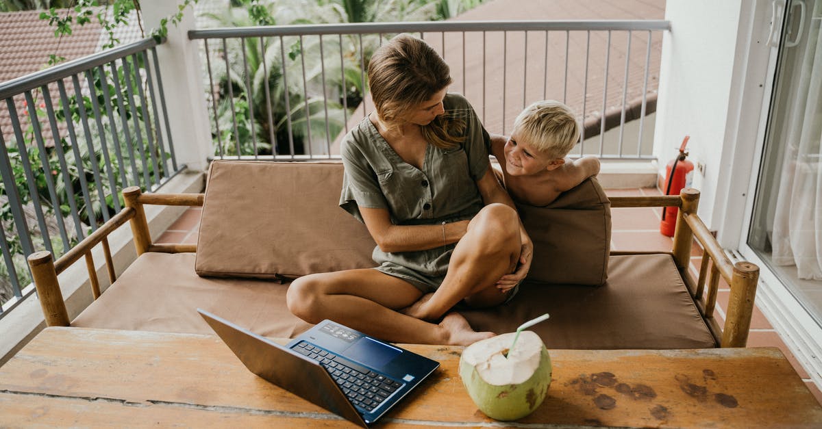 UK visitor Visa for child with mother - Man and Woman Sitting on Brown Couch Using Macbook UK visitor Visa for child with mother - Man and Woman Sitting on Brown Couch Using Macbook