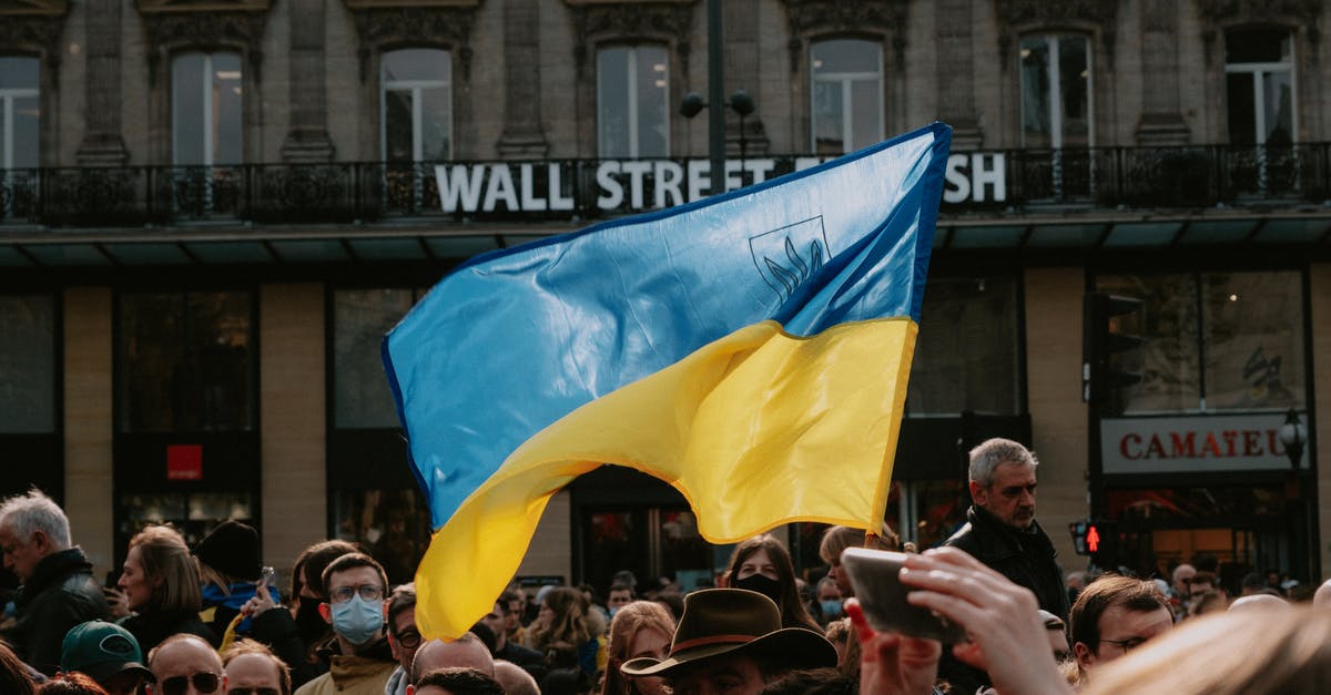 Ukrainian biometric passports - Blue and yellow Ukrainian Flag Waving Above Crowd of People Ukrainian biometric passports - Blue and yellow Ukrainian Flag Waving Above Crowd of People