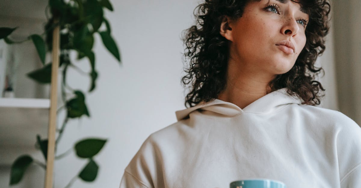 Uncertain about Schengen visa application question about residency type - Pensive woman with hot beverage at home Uncertain about Schengen visa application question about residency type - Pensive woman with hot beverage at home