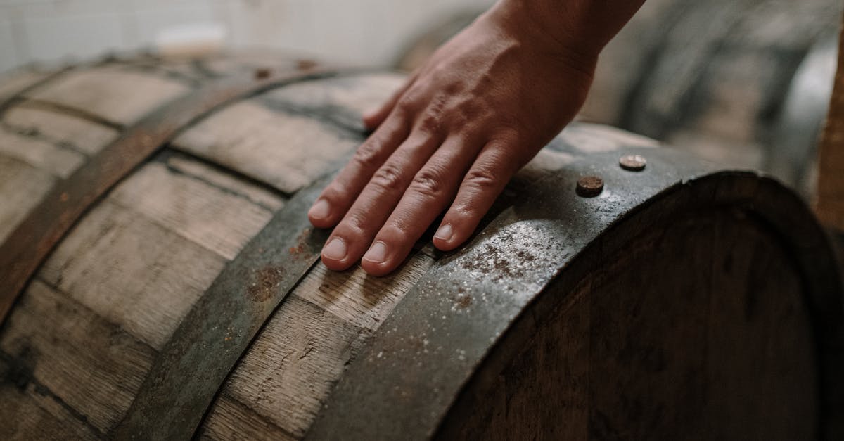 Under seat hand luggage storage width on Boeing 737-800 [closed] - A Person Holding a Brown Wooden Barrel