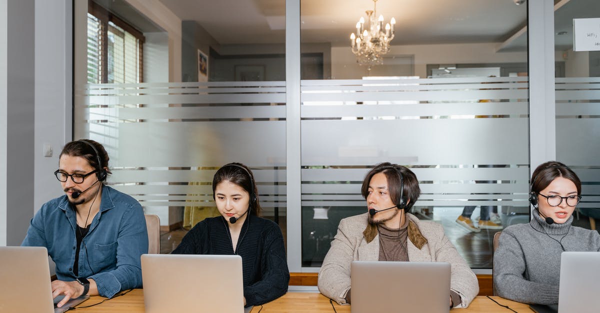 Understanding how customs work with laptops - Multiracial Employees Sitting in Front of Silver Laptops Understanding how customs work with laptops - Multiracial Employees Sitting in Front of Silver Laptops