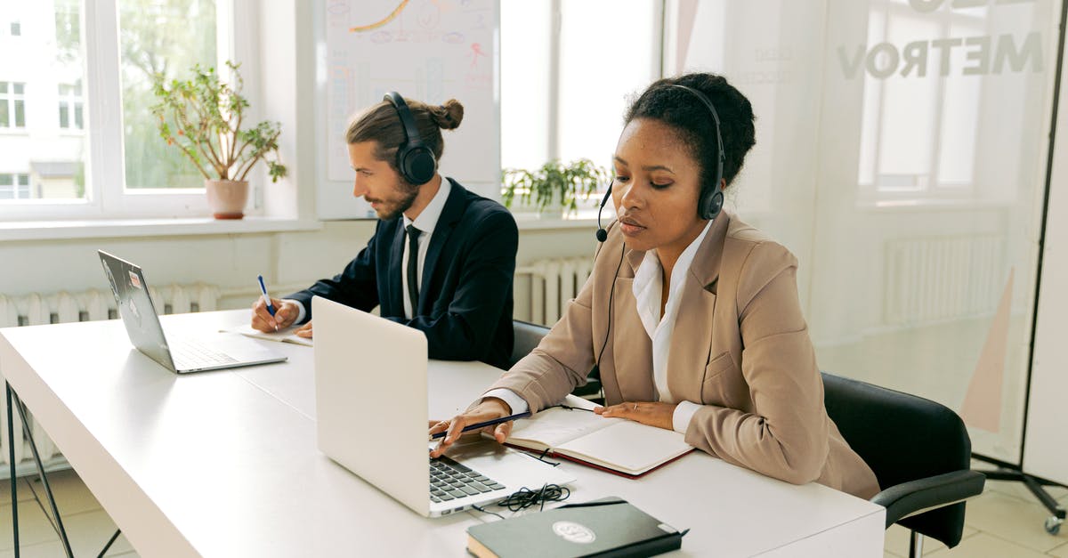 Understanding how customs work with laptops - Man and Woman Working Wearing Headsets Understanding how customs work with laptops - Man and Woman Working Wearing Headsets