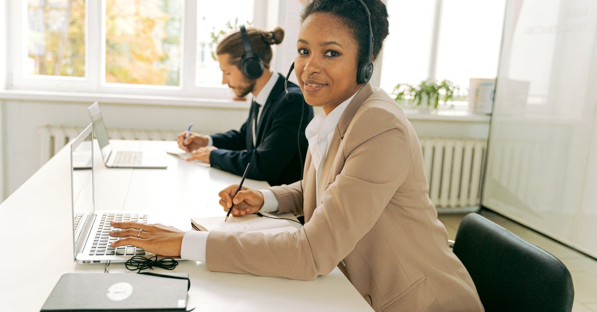 Understanding how customs work with laptops - Woman in Beige Blazer Sitting on Chair Beside a Man in Black Suit Understanding how customs work with laptops - Woman in Beige Blazer Sitting on Chair Beside a Man in Black Suit