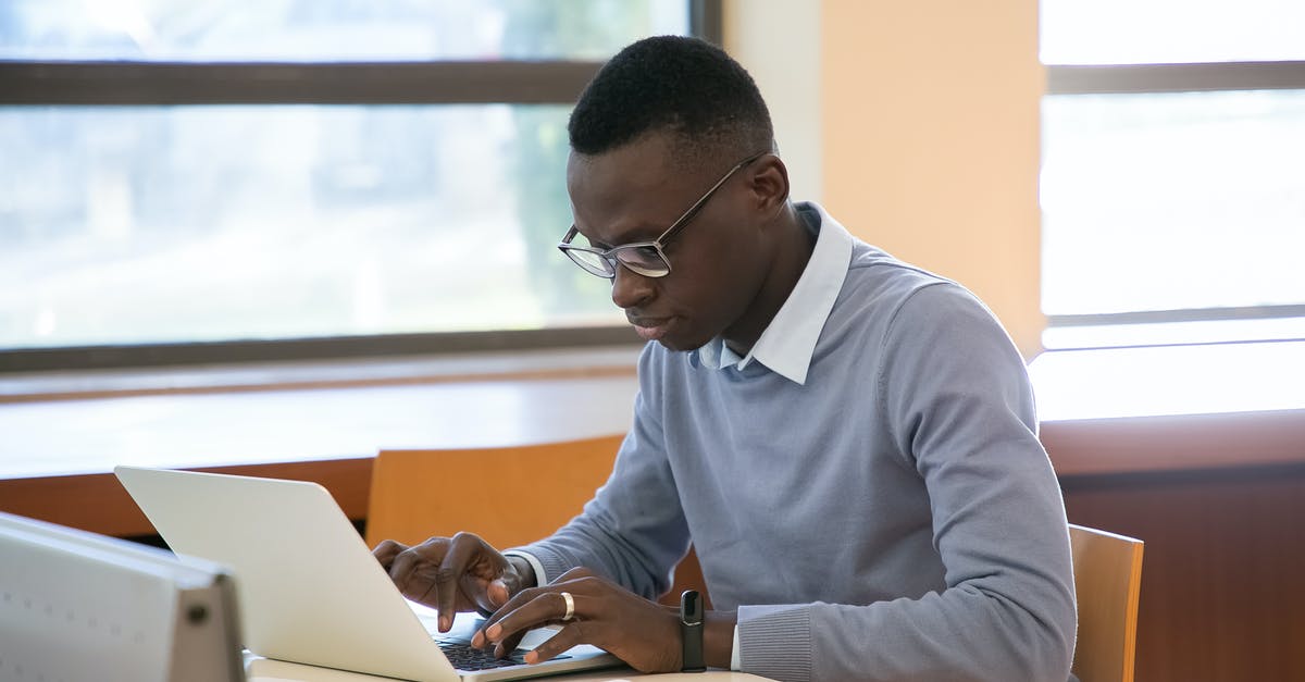 Unlimited data plan to use In the whole of Europe for YouTube streaming [closed] - Concentrated young African American male student in formal clothes and eyeglasses reading notes in planner and typing on laptop while doing assignment in modern workspace