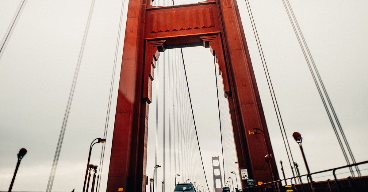 Unlimited-ride pass on San Francisco BART - Cars riding along asphalt surface of famous Golden Gate Bridge in San Francisco on cloudy overcast day Unlimited-ride pass on San Francisco BART - Cars riding along asphalt surface of famous Golden Gate Bridge in San Francisco on cloudy overcast day