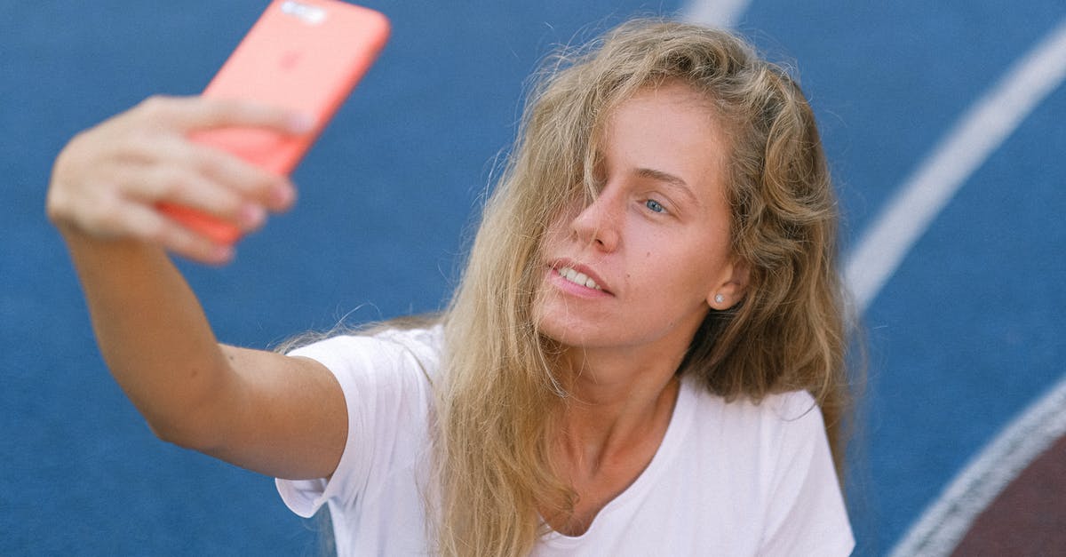 unlock a AT&T phone outside US - Lady using smartphone for photo on court unlock a AT&T phone outside US - Lady using smartphone for photo on court