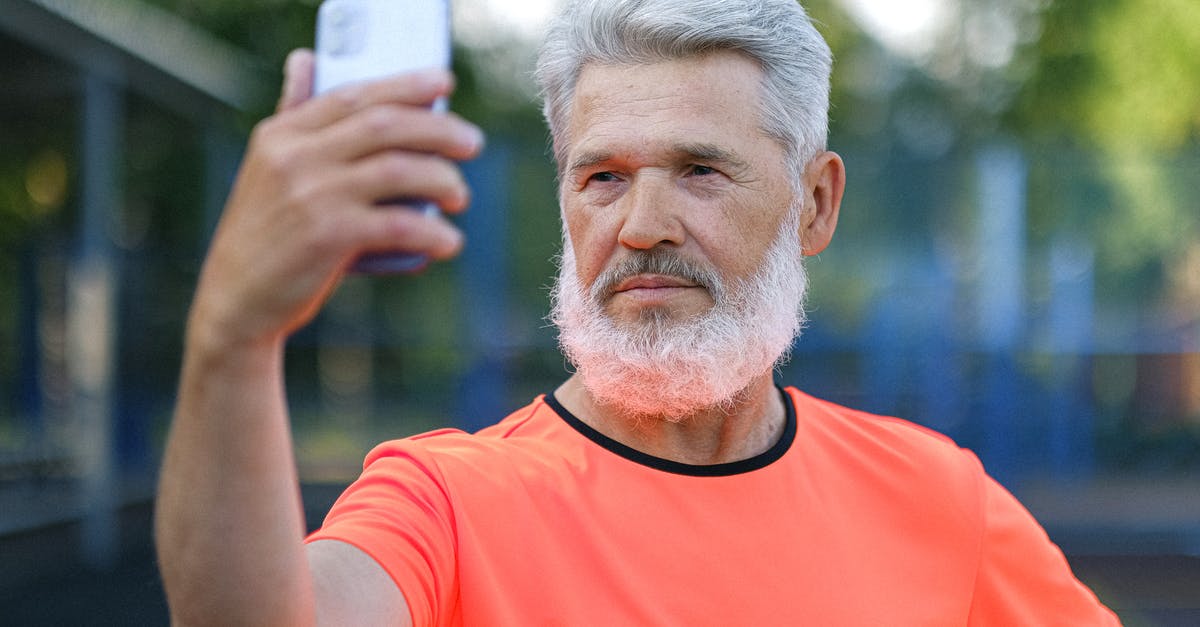 unlock a AT&T phone outside US - Serious aged man taking selfie on smartphone unlock a AT&T phone outside US - Serious aged man taking selfie on smartphone