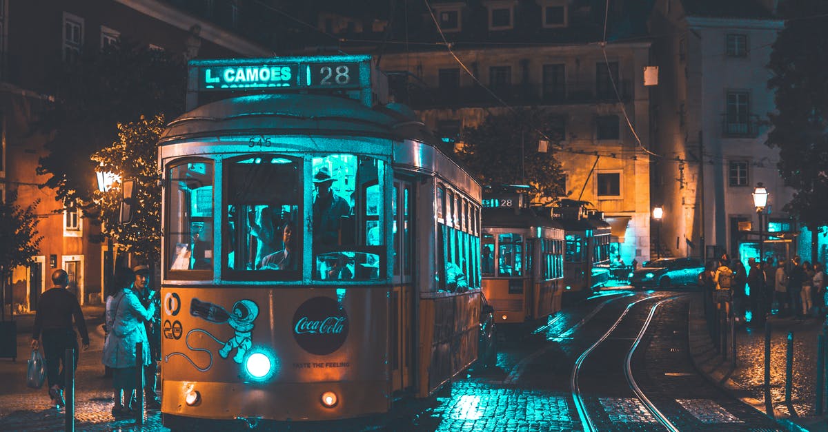 Urban exploration in Lisbon area, Portugal - Photo of People Riding on City Tram Urban exploration in Lisbon area, Portugal - Photo of People Riding on City Tram