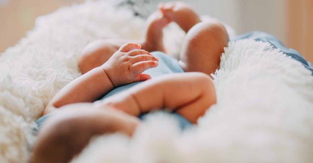 US born but as a child of foreign diplomat - Photo Of Baby Laying On Fleece Blanket