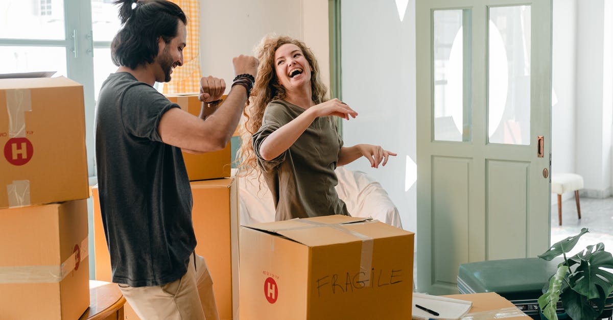 US Boyfriend visiting me (UK citizen) for 6 weeks having just sold house - Cheerful laughing couple in casual clothes having fun and dancing together while unpacking carton boxes after moving into new contemporary apartment US Boyfriend visiting me (UK citizen) for 6 weeks having just sold house - Cheerful laughing couple in casual clothes having fun and dancing together while unpacking carton boxes after moving into new contemporary apartment