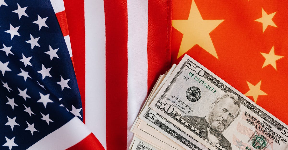 US citizen traveling to China on Q2 visa - COVID19 - American and Chinese flags and USA dollars US citizen traveling to China on Q2 visa - COVID19 - American and Chinese flags and USA dollars