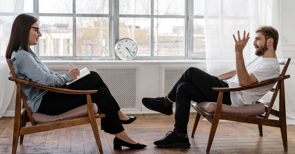US Healthcare consultation for visitors - Person in Black Pants and Black Shoes Sitting on Brown Wooden Chair US Healthcare consultation for visitors - Person in Black Pants and Black Shoes Sitting on Brown Wooden Chair