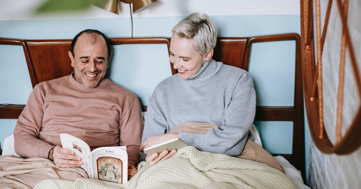 US I-130 denied under INA 204-c, will this affect my Employment Visa Application to Ireland? [closed] - Happy diverse couple smiling and reading book together while resting in bed