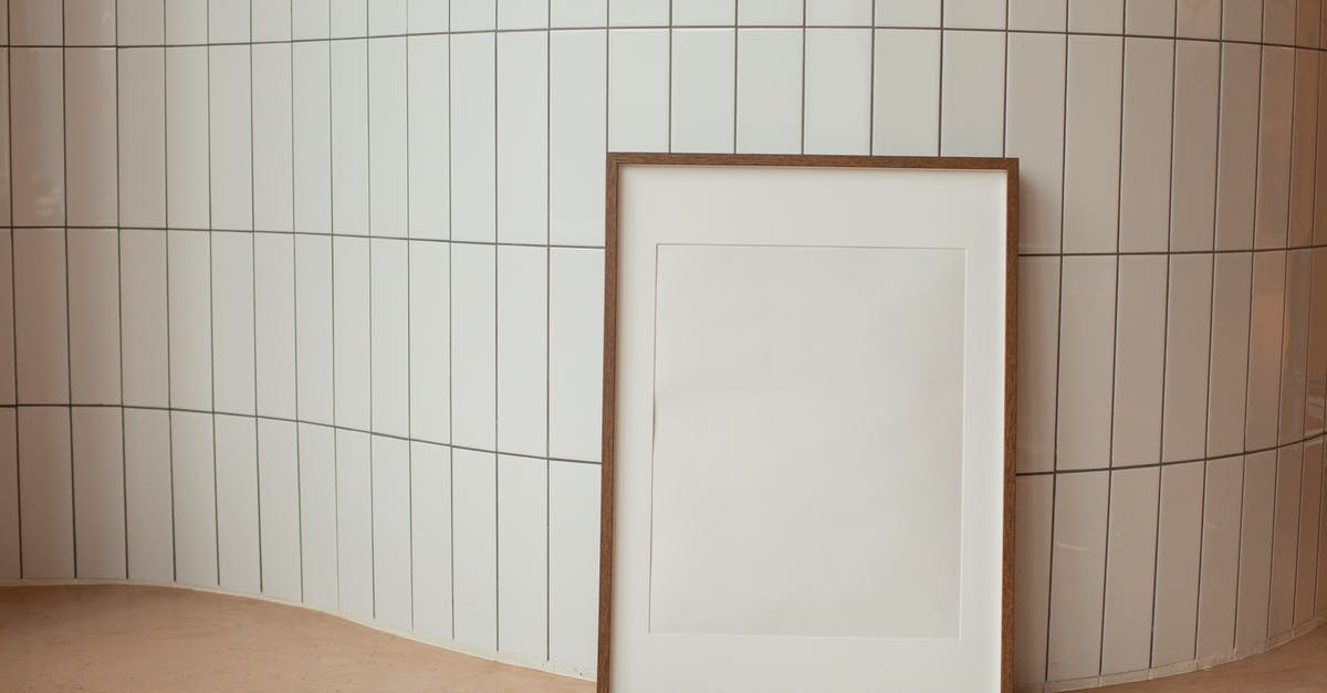 US Passport - Laminated Photo has a white blemish - Rectangular empty photo frame against tiled wall US Passport - Laminated Photo has a white blemish - Rectangular empty photo frame against tiled wall