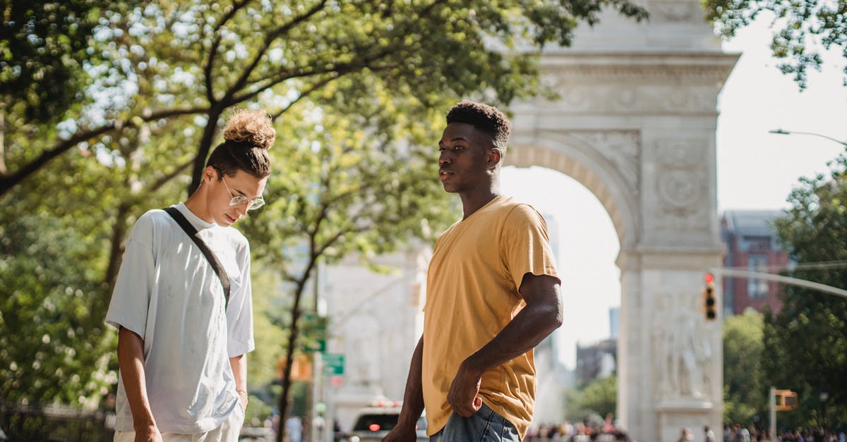 US Preclearance time at Abu Dhabi - (AUH - MAN - ORD) - Stylish young multiethnic male friends in casual clothes standing on street near Washington Square Arch on sunny day in New York US Preclearance time at Abu Dhabi - (AUH - MAN - ORD) - Stylish young multiethnic male friends in casual clothes standing on street near Washington Square Arch on sunny day in New York