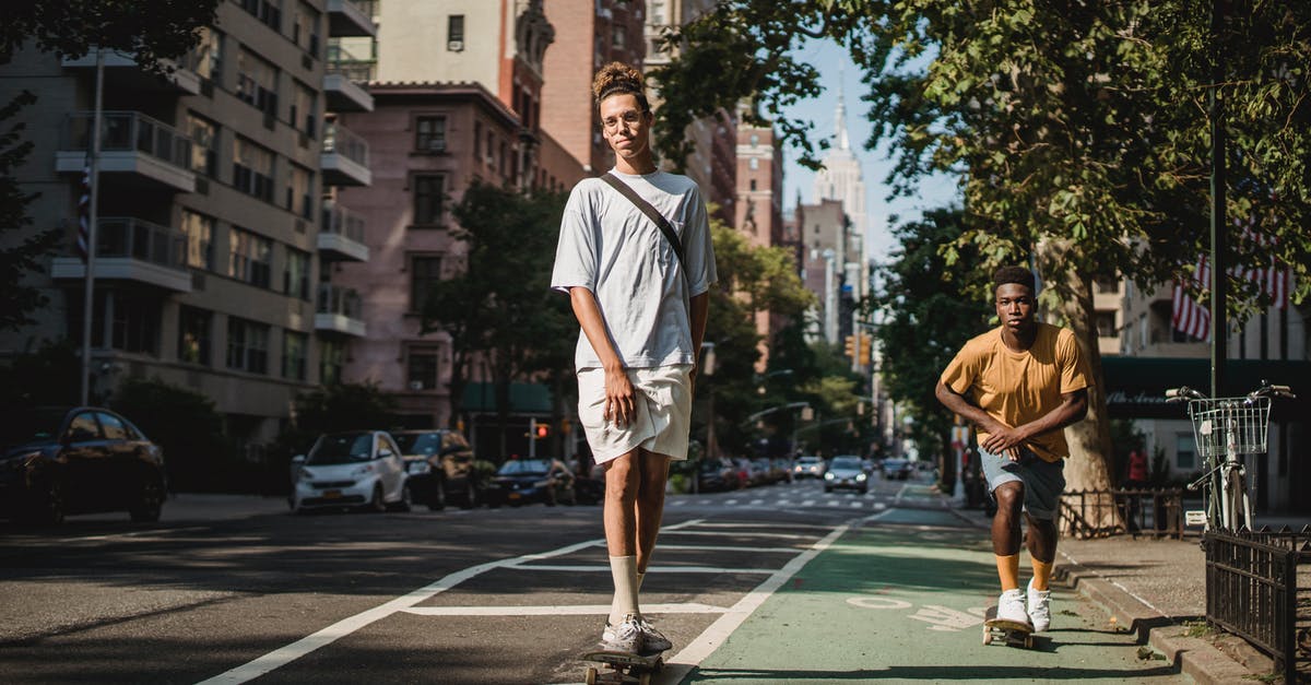 US Preclearance time at Abu Dhabi - (AUH - MAN - ORD) - Stylish young multiethnic men riding skateboards on city street US Preclearance time at Abu Dhabi - (AUH - MAN - ORD) - Stylish young multiethnic men riding skateboards on city street