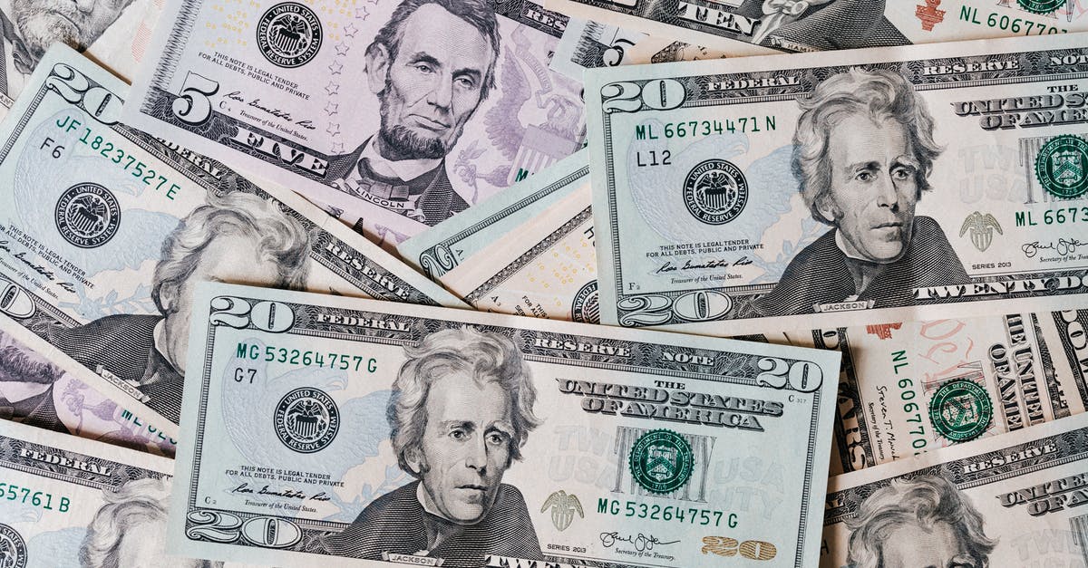 US tourism/business visa from non-resident country - Top view of different types and colors American dollars placed together on each other US tourism/business visa from non-resident country - Top view of different types and colors American dollars placed together on each other