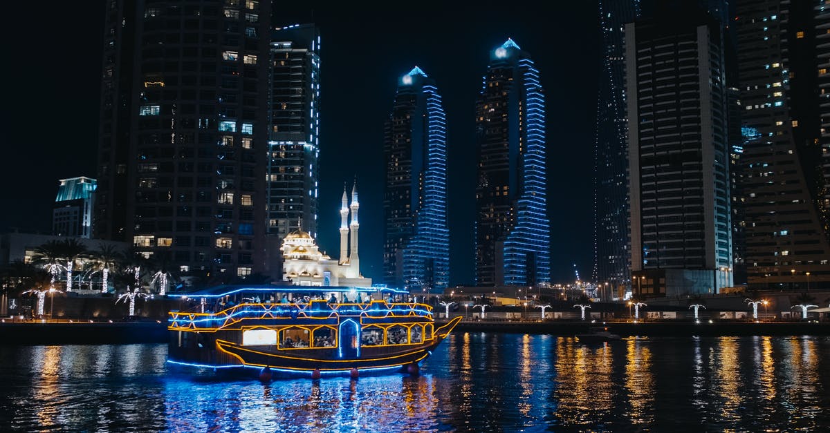 US Visa for Alaska cruise - A Boat Sailing on River Near City Buildings during Night US Visa for Alaska cruise - A Boat Sailing on River Near City Buildings during Night