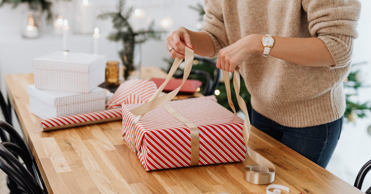 US visitor with gifts over $100. How much hassle? - Person Holding White and Red Striped Tote Bag