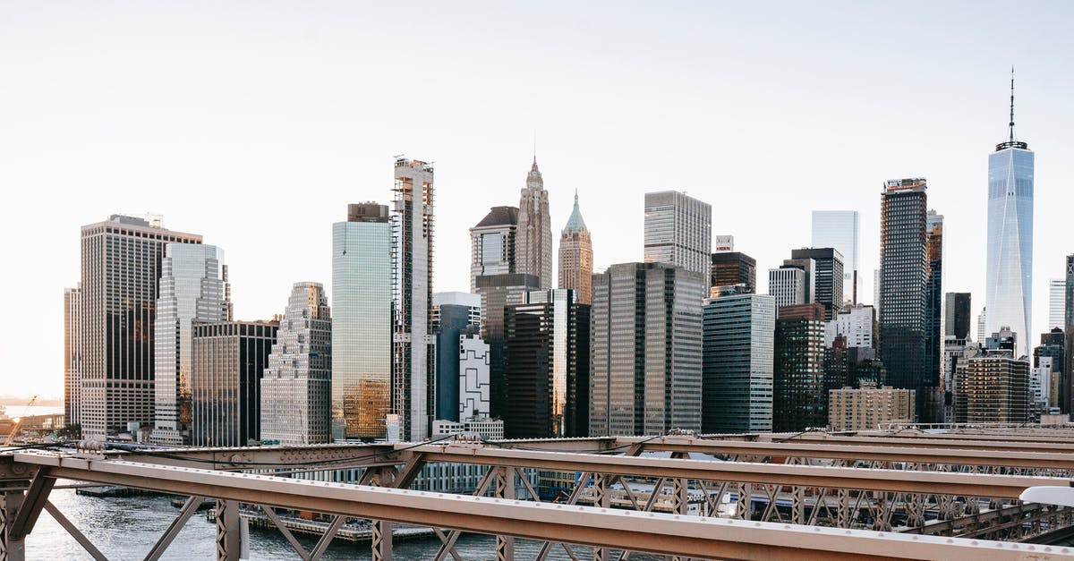 USA car rental one-way fee - Business district behind river and bridge USA car rental one-way fee - Business district behind river and bridge