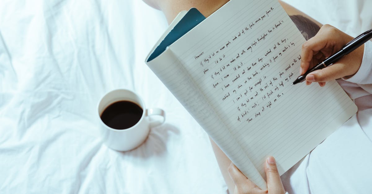 USA: cellular plans with domestic roaming - Top view of unrecognizable woman sitting on bed with legs near cup of coffee and writing on notepad with pen while resting at home USA: cellular plans with domestic roaming - Top view of unrecognizable woman sitting on bed with legs near cup of coffee and writing on notepad with pen while resting at home