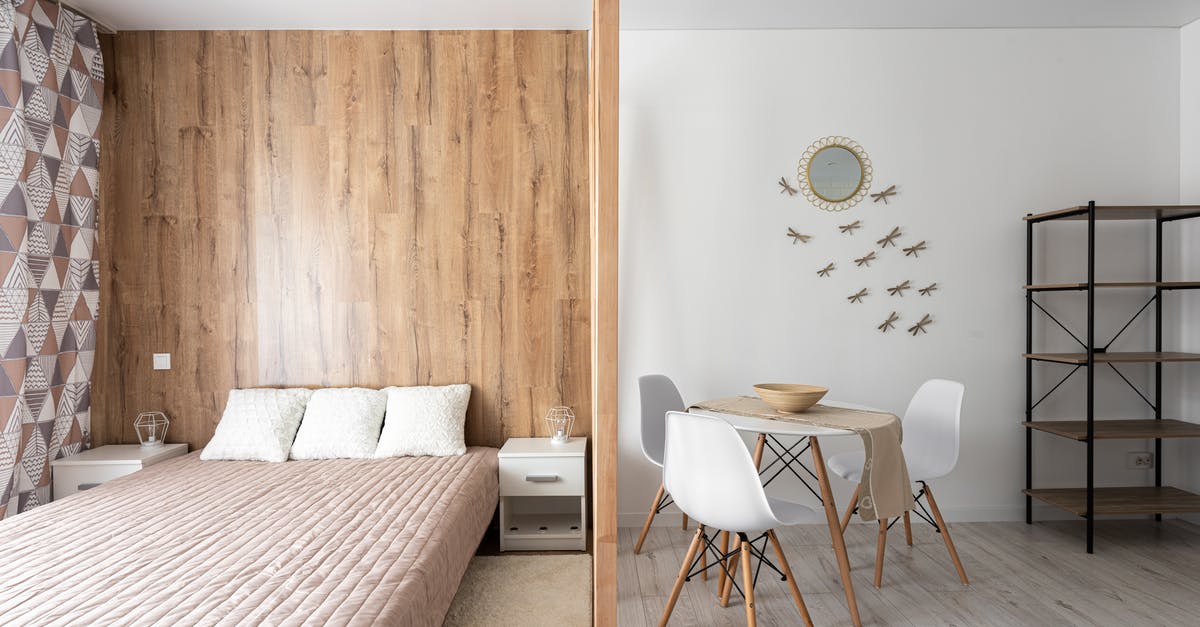 USA: cellular plans with domestic roaming - Bed with cushions against table and chairs on floor at home with empty shelves and decorative dragonflies on wall USA: cellular plans with domestic roaming - Bed with cushions against table and chairs on floor at home with empty shelves and decorative dragonflies on wall