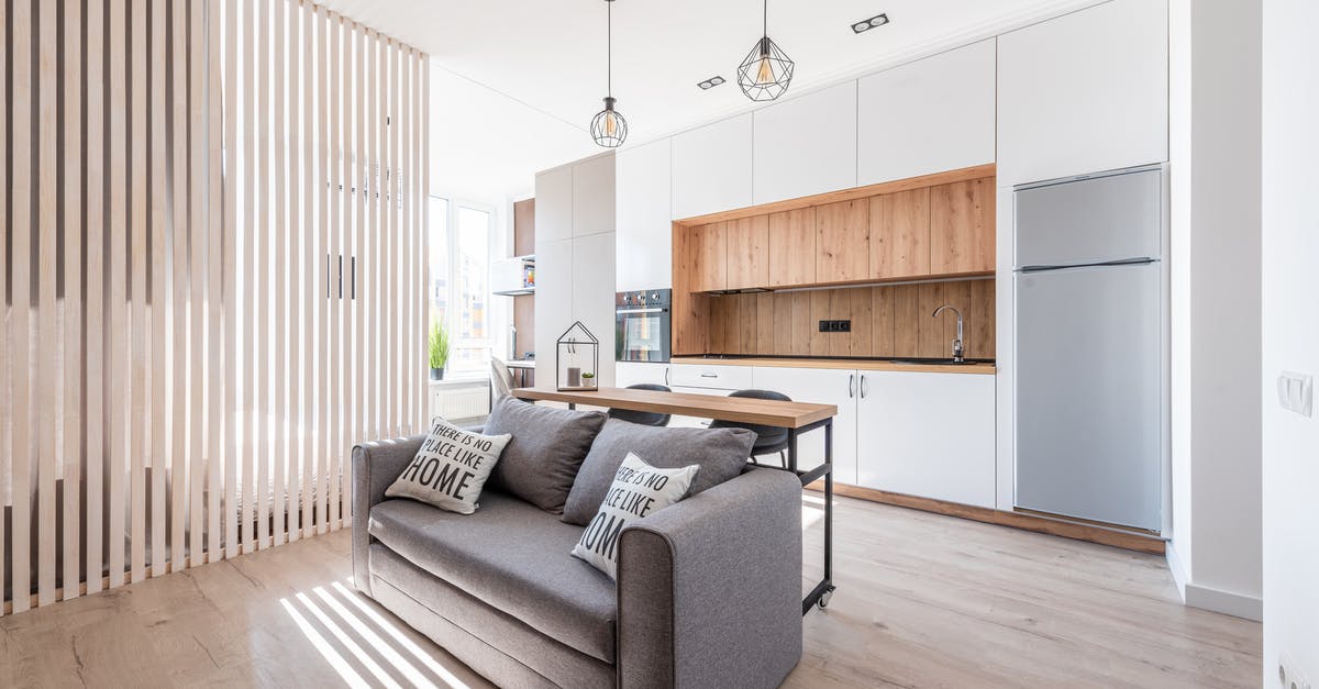 USA: cellular plans with domestic roaming - Interior of contemporary open plan kitchen with white cabinets and cozy sofa with cushions in sunlight USA: cellular plans with domestic roaming - Interior of contemporary open plan kitchen with white cabinets and cozy sofa with cushions in sunlight