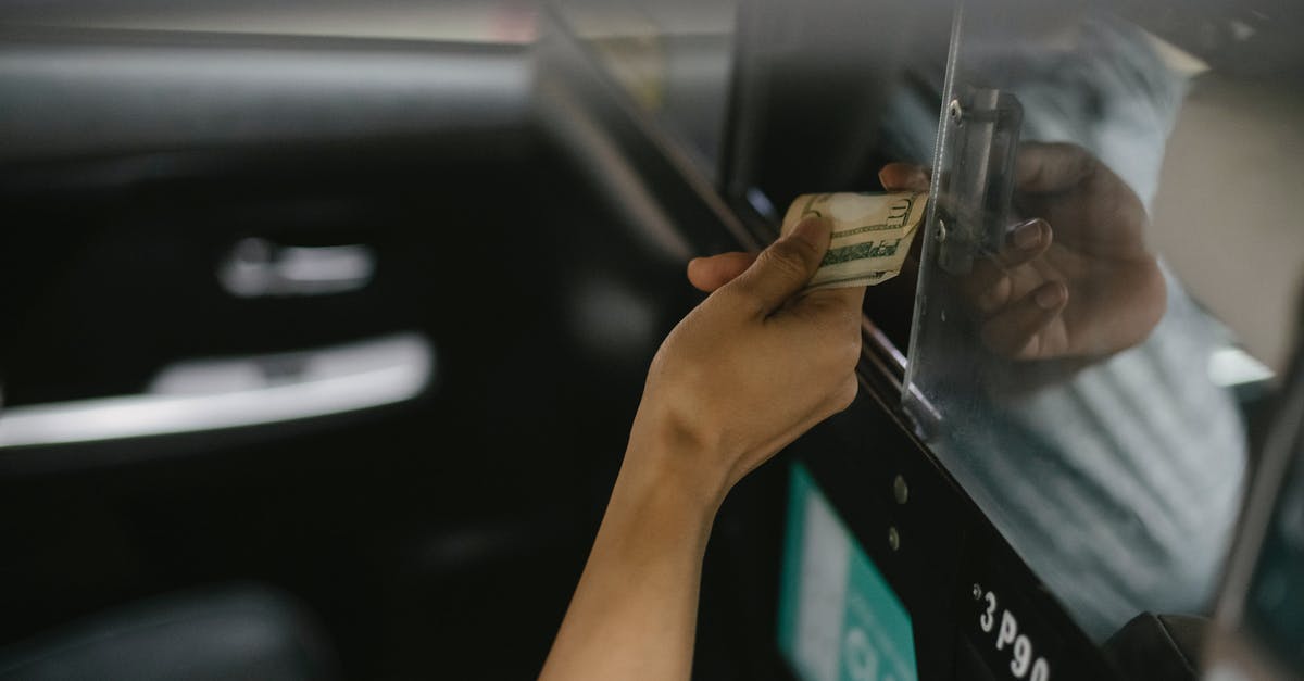 USA fingerprint on arrival - Interior of modern taxi car while passenger paying for ride USA fingerprint on arrival - Interior of modern taxi car while passenger paying for ride