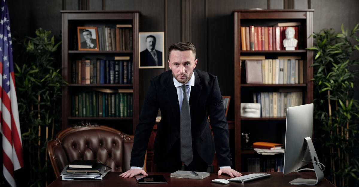 USA visa law for dual Canadian-UK citizen - Businessman in his Office Looking at the Camera USA visa law for dual Canadian-UK citizen - Businessman in his Office Looking at the Camera