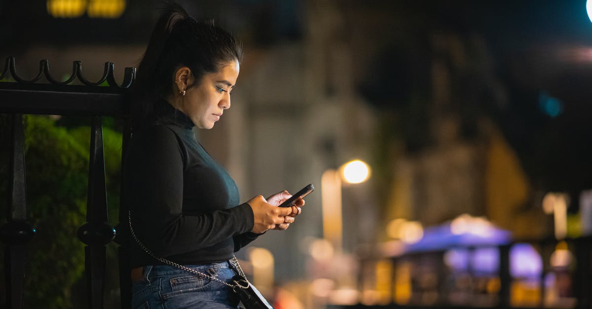 Using a quad-band phone in Japan? - Woman Using Phone on a Street at Night Using a quad-band phone in Japan? - Woman Using Phone on a Street at Night