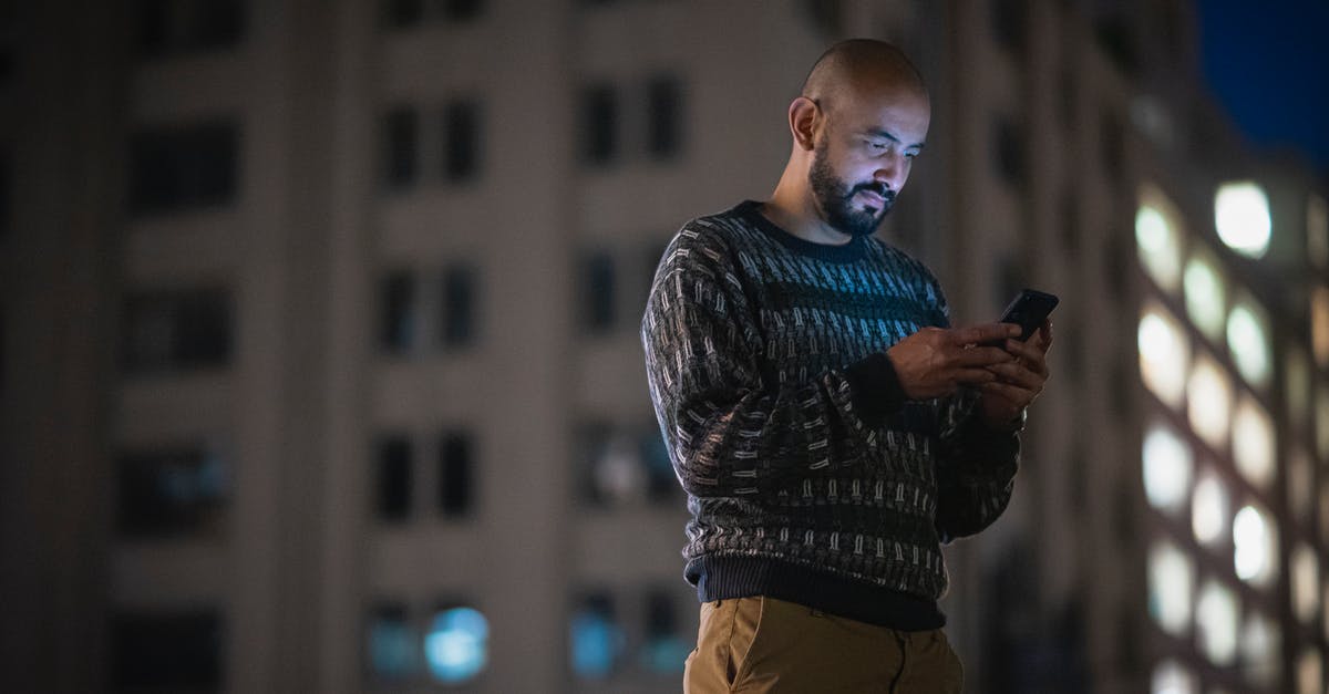 Using a quad-band phone in Japan? - Man with Beard Using a Phone in a Street Using a quad-band phone in Japan? - Man with Beard Using a Phone in a Street