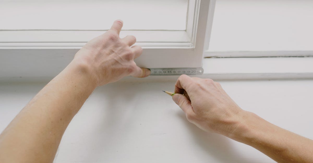 Using APC kiosk with new ESTA/passport - From above of crop unrecognizable male worker measuring window frame with metal ruler and pencil in house Using APC kiosk with new ESTA/passport - From above of crop unrecognizable male worker measuring window frame with metal ruler and pencil in house