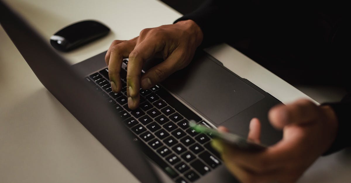 Using Bank Statement from Online Banking for Canada Visa application - Crop faceless man typing on laptop and using smartphone Using Bank Statement from Online Banking for Canada Visa application - Crop faceless man typing on laptop and using smartphone