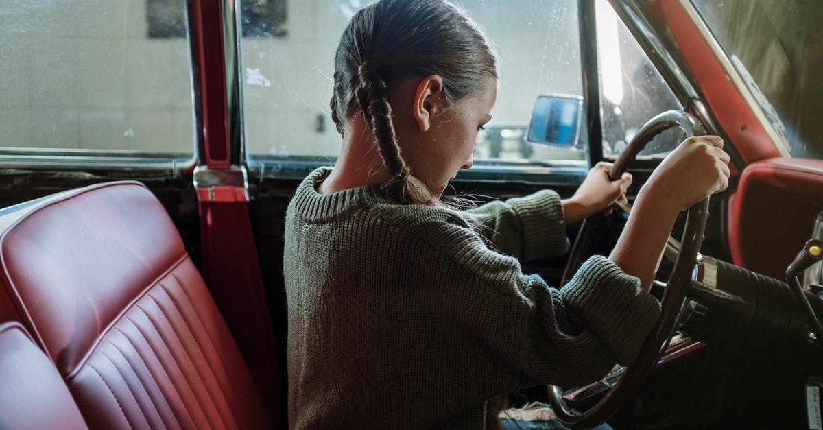 Using child car seats in Cuba? - Woman in Gray Sweater Sitting on Red Car Seat Using child car seats in Cuba? - Woman in Gray Sweater Sitting on Red Car Seat