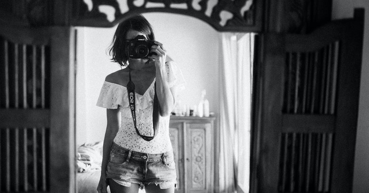 Using Incheon’s Transit Hotel - Black and white of casual female photographer in summer clothes standing against mirror in light room and taking photo with camera Using Incheon’s Transit Hotel - Black and white of casual female photographer in summer clothes standing against mirror in light room and taking photo with camera