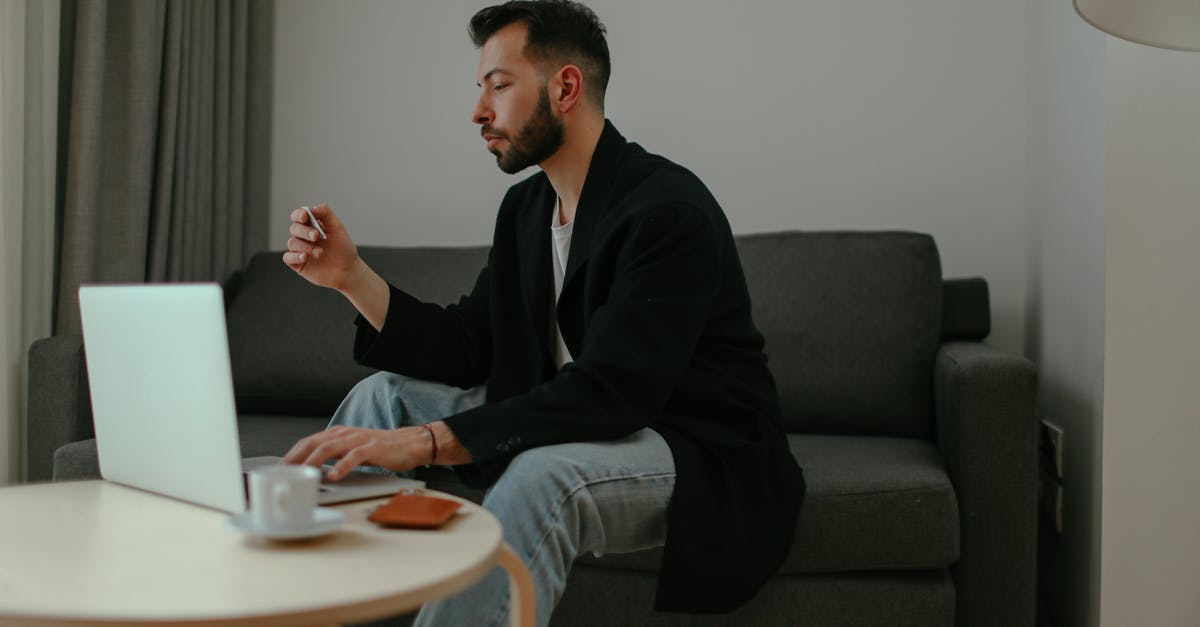 Using LG V10 or Motorola in Japan - Man in Black Blazer and Denim Pants Sitting on a Couch while Using a Laptop Using LG V10 or Motorola in Japan - Man in Black Blazer and Denim Pants Sitting on a Couch while Using a Laptop