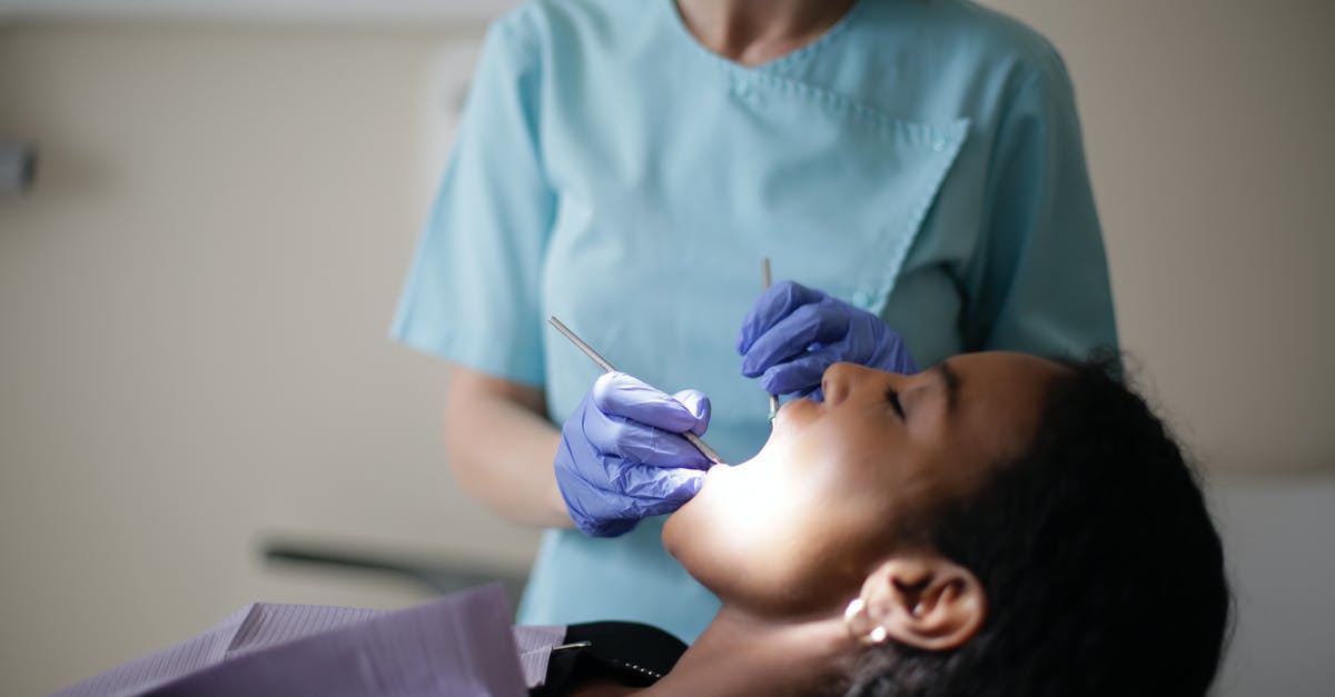 Using my UK Multi Visit visa - Stomatologist with tools treating teeth of patient Using my UK Multi Visit visa - Stomatologist with tools treating teeth of patient