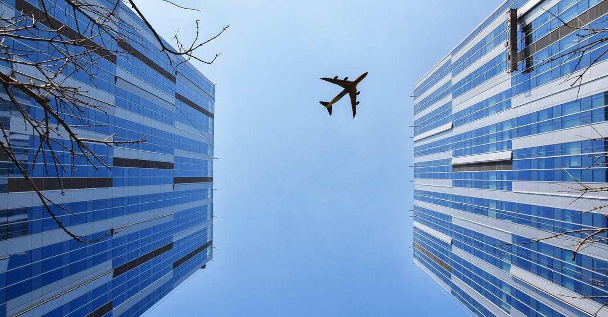 Using restroom on airplane while fasten seatbelt light is on? - Airplane Near Blue and Grey Building Using restroom on airplane while fasten seatbelt light is on? - Airplane Near Blue and Grey Building