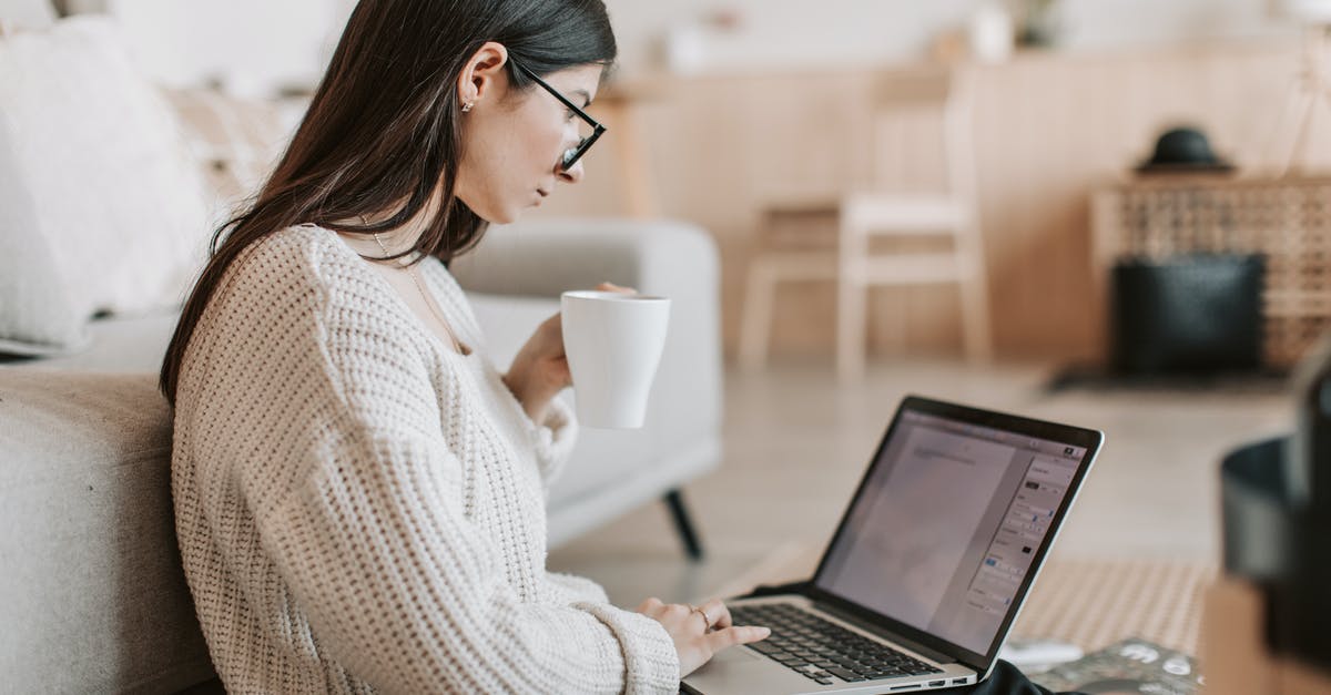 Using Sworn Affidavit as additional Document for Business name Registration for TRV Canada - Side view of female freelancer in warm sweater and eyeglasses drinking tea from white ceramic cup while sitting on floor near sofa with netbook on legs while creating document for remote work project Using Sworn Affidavit as additional Document for Business name Registration for TRV Canada - Side view of female freelancer in warm sweater and eyeglasses drinking tea from white ceramic cup while sitting on floor near sofa with netbook on legs while creating document for remote work project