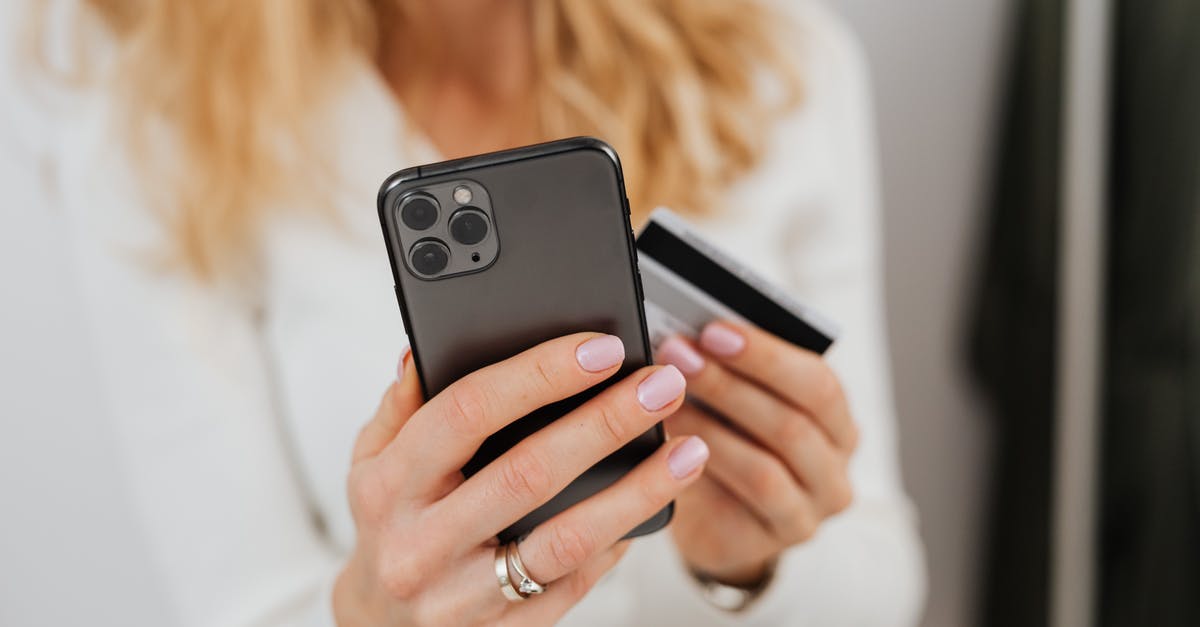 Using US iPhone 6 in Europe - Close-Up Shot of a Person Holding a Credit Card and a Smartphone Using US iPhone 6 in Europe - Close-Up Shot of a Person Holding a Credit Card and a Smartphone