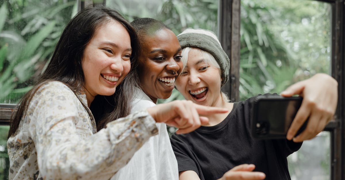 Vantage point in Austin, Texas for photos? - Cheerful diverse female friends laughing at just taken selfie Vantage point in Austin, Texas for photos? - Cheerful diverse female friends laughing at just taken selfie