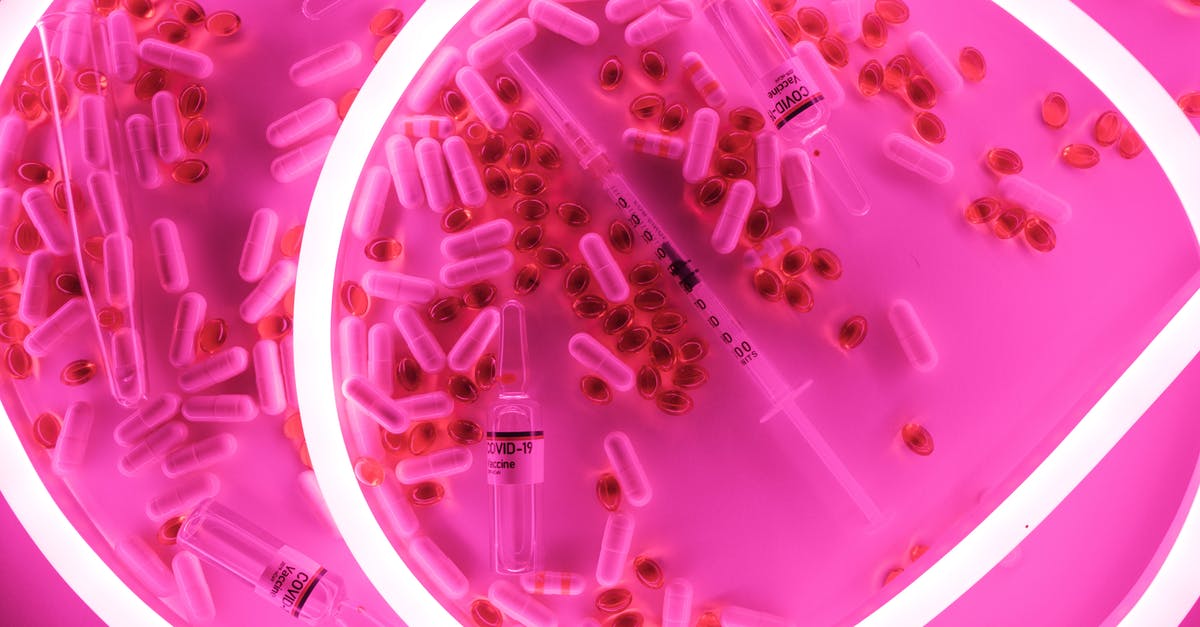 Various covid certificates for vaccinations done in Canada - Medical syringe and pills with capsules placed in bright light Various covid certificates for vaccinations done in Canada - Medical syringe and pills with capsules placed in bright light