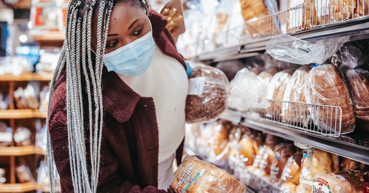 Various covid certificates for vaccinations done in Canada - Black woman choosing bread in baking department Various covid certificates for vaccinations done in Canada - Black woman choosing bread in baking department