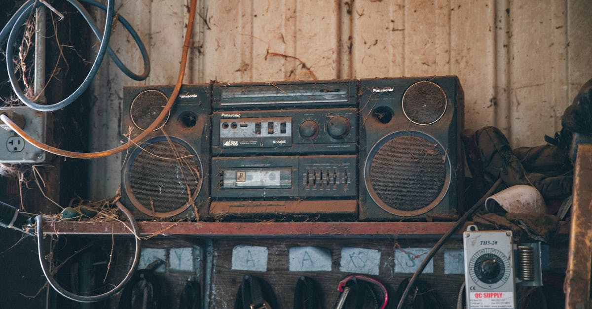 VAT Refund on Used Musical Instruments - Old fashioned obsolete compact stereo system covered with dust placed on shelf near wooden wall in workshop with tools and wires VAT Refund on Used Musical Instruments - Old fashioned obsolete compact stereo system covered with dust placed on shelf near wooden wall in workshop with tools and wires