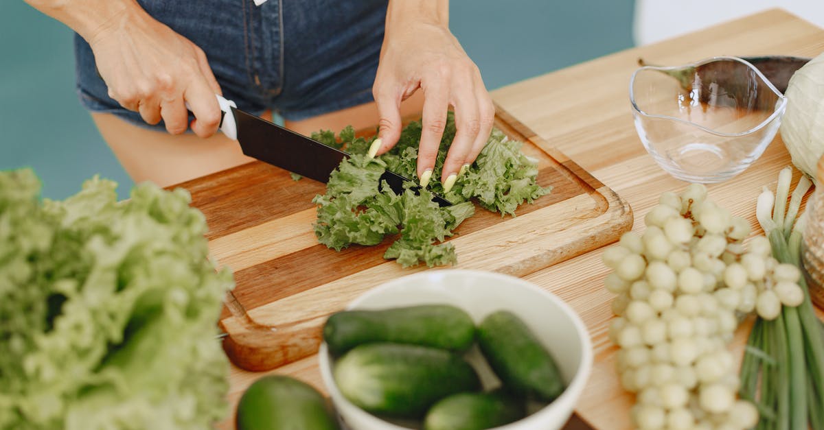 Vegetarian food in Morocco - Person Slicing Green Vegetable on Brown Wooden Chopping Board Vegetarian food in Morocco - Person Slicing Green Vegetable on Brown Wooden Chopping Board