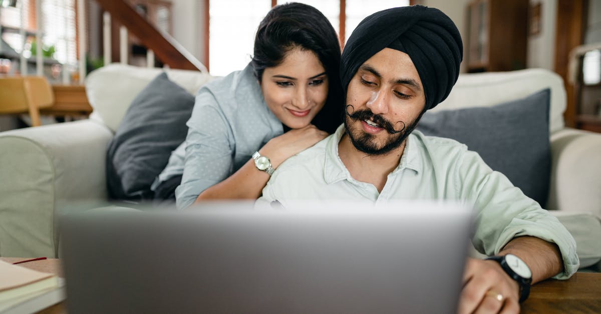 Visa needed for the wife of a British citizen to live together in Spain [closed] - Cheerful ethnic couple using laptop and smiling